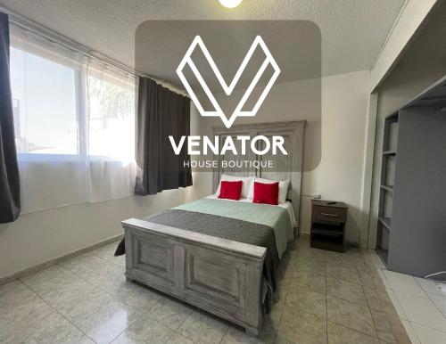 a bedroom with a bed with a sign on the wall at 7 VENATOR House Boutique in León
