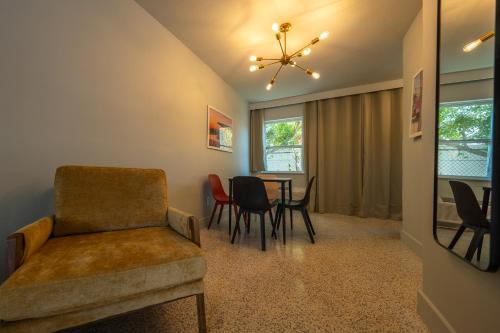 a living room with a chair and a table at Tropical Breeze in Clearwater Beach
