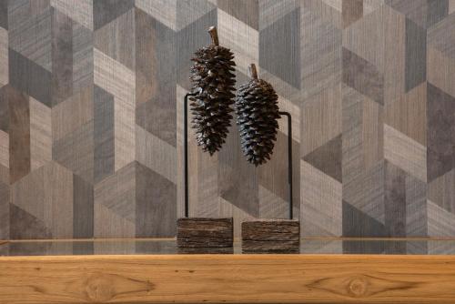 two plants in vases on a table with a wall at Holiday Inn Express South Burlington - Downtown by IHG in Burlington