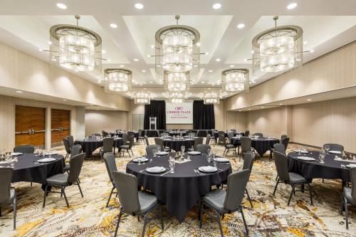a banquet room with tables and chairs and chandeliers at Crowne Plaza Seattle Newly Renovated with No Resort Fee in Seattle