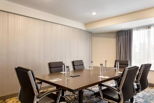 a conference room with a wooden table and chairs at Crowne Plaza Seattle Newly Renovated with No Resort Fee in Seattle