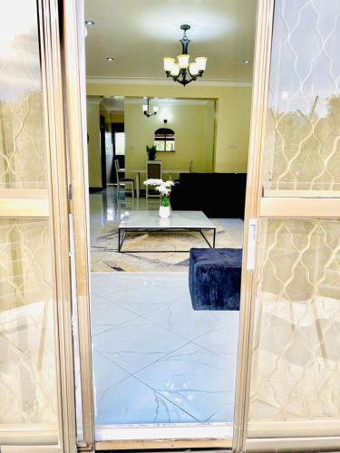 a view of a lobby with a table and a living room at Hidden beautiful Modern Apartment in Entebbe