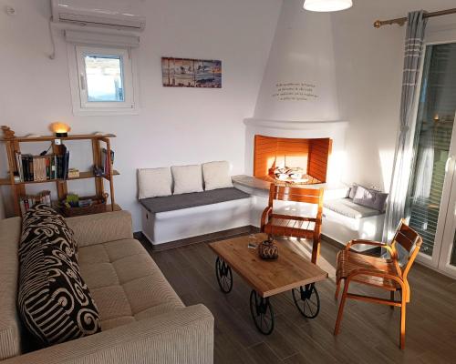 a living room with a couch and a fireplace at Sweet Home Nikorenia 2 in Krotiri