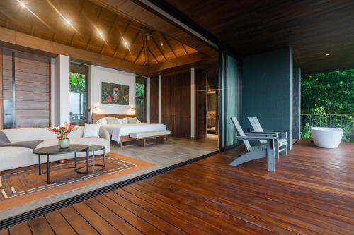 a living room with a couch and a table at Rancho Pacifico - Boutique Hotel for Adults in Uvita