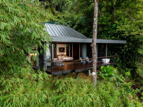 a house in the middle of a forest at Rancho Pacifico - Boutique Hotel for Adults in Uvita