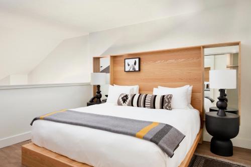 a bedroom with a large bed and two lamps at Gravity Haus Jackson Hole in Teton Village