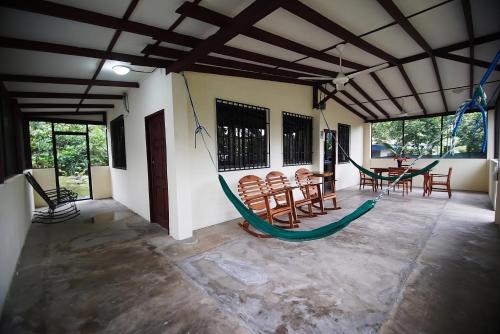 a room with chairs and a hammock in it at Pavones Point Surf House in Great Location in Pavones