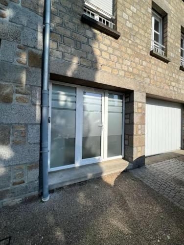 a large glass garage door on a brick building at IL punto in Avranches