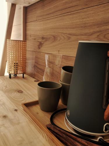 a table with two cups on top of a wooden floor at Habitaciones con encanto en Ilurdoz in Zuriáin