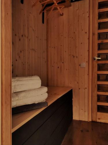 a sauna with towels sitting on a wooden shelf at Habitaciones con encanto en Ilurdoz in Zuriáin
