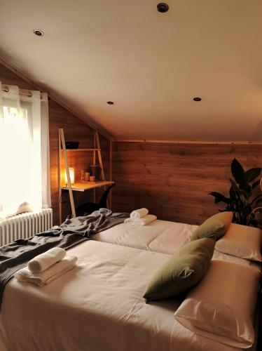 a large white bed with pillows on top of it at Habitaciones con encanto en Ilurdoz in Zuriáin