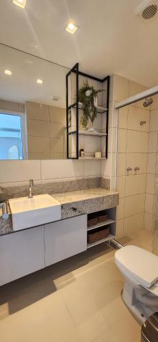 a bathroom with a sink and a toilet at Parque do Cais - Flats Premium no Recife por Yolo in Recife
