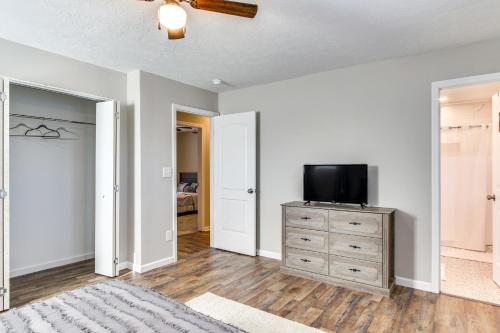 a living room with a tv on a dresser with a dresser at 6 Mi to The Masters Updated Home with Yard! in Augusta