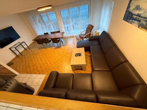 a living room with a couch and a table at Lake View Residence in Niederried