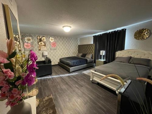 a bedroom with a bed and a couch in it at The Village Inn Hotel in Milwaukee