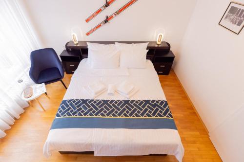 a bedroom with a bed and a blue chair at Retro house in Kamnik in Kamnik