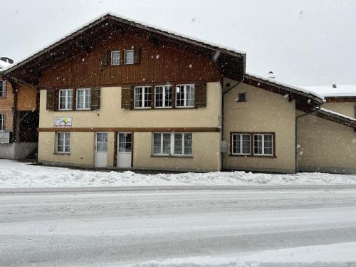 a house in the snow in front of a street at Royal Swiss Apartments in Ringgenberg