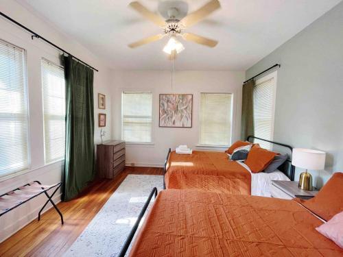 a bedroom with two beds and a ceiling fan at Southern Comfort Oasis in Beaumont