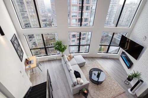 an overhead view of a living room with large windows at Loft in Entertainment District with FREE underground Parking in Vancouver