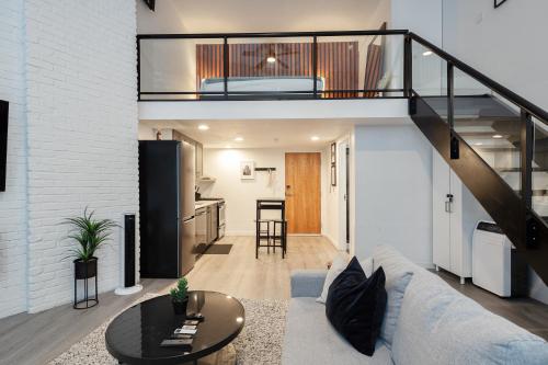 a living room with a couch and a loft at Loft in Entertainment District with FREE underground Parking in Vancouver