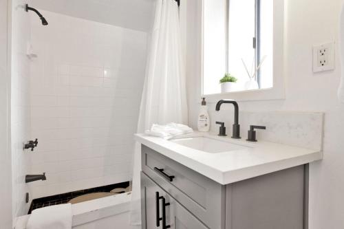 a white bathroom with a sink and a shower at Large Bear Lodge by Big Bear Vacations in Sugarloaf