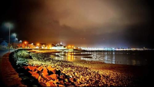 a view of a beach at night with lights at Castle Place in Newcastle