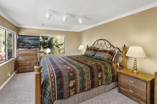 a bedroom with a bed and a dresser and a window at Highland Oaks Retreat by Big Bear Vacations in Sugarloaf