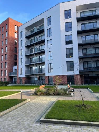 a apartment building with a park in front of it at Cozy room in a shared apartment in Lucan
