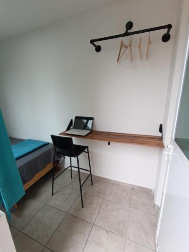 a bedroom with a desk with a laptop on it at Comfortable Retreat in Cocoyoc Pool & BBQ in Cocoyoc