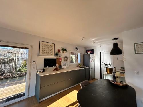 - une cuisine avec un réfrigérateur et une table dans la chambre dans l'établissement House with a hidden garden, à La Roche-sur-Foron