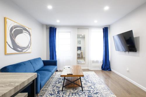 a living room with a blue couch and a table at 350-2A Prime gramercy Newly renovated 1BR sleeps 4 in New York