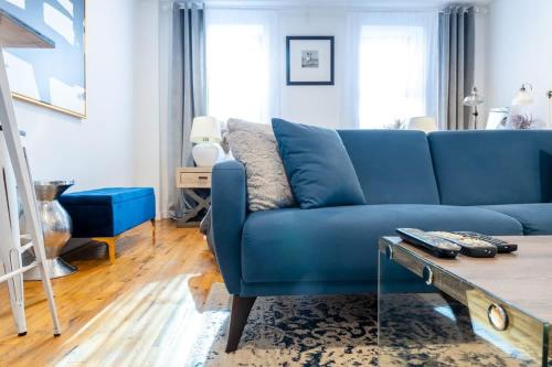 a blue couch in a living room with a table at 350-GA Spacious Studio Gramercy Sleeps 3 in New York