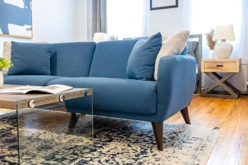 a blue couch in a living room with a coffee table at 350-GA Spacious Studio Gramercy Sleeps 3 in New York