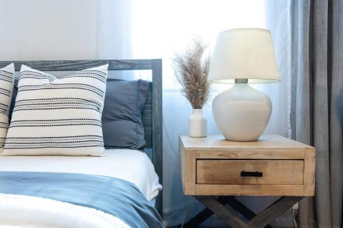 a lamp on a night stand next to a bed at 350-GA Spacious Studio Gramercy Sleeps 3 in New York