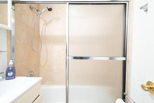 a shower with a glass door in a bathroom at 350-GA Spacious Studio Gramercy Sleeps 3 in New York