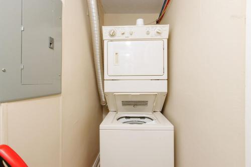 a washer and dryer in a corner of a room at Stunning Apt w Rooftop & Game Room - Sleeps 10 in Pittsburgh