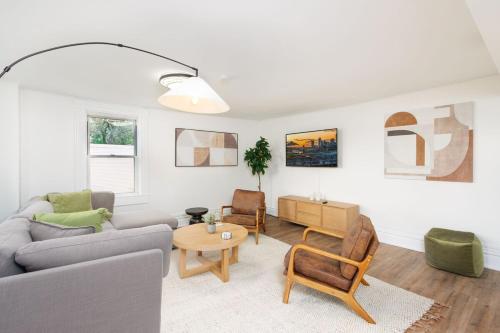 a living room with a couch and a table at Stunning Apt w Rooftop & Game Room - Sleeps 10 in Pittsburgh