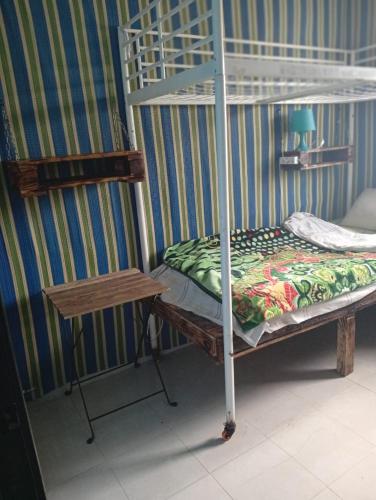 a bunk bed in a room with a table and a bunk bed gmaxwell gmaxwell gmaxwell at Nouvelle ville Ibn Battouta in Tangier