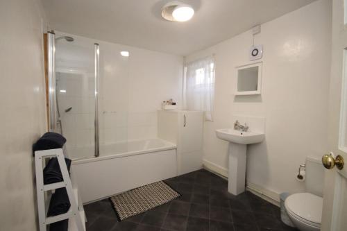 a bathroom with a shower sink and a toilet at City heights Central location in Canterbury
