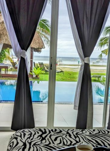 a view of the ocean from a room with a window at Bohol South Beach Hotel in Panglao