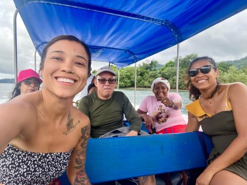 a group of people on a boat in the water at La Bamba in Termales - agua caliente - nuqui
