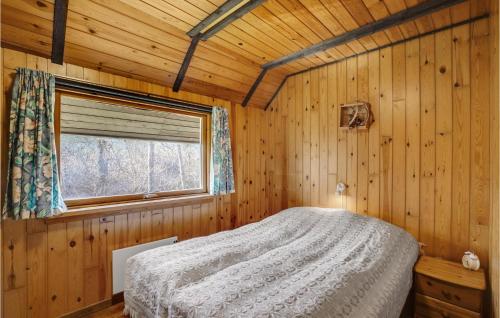 a bedroom with a bed in a wooden cabin at 4 Bedroom Pet Friendly Home In Løgstør in Løgsted