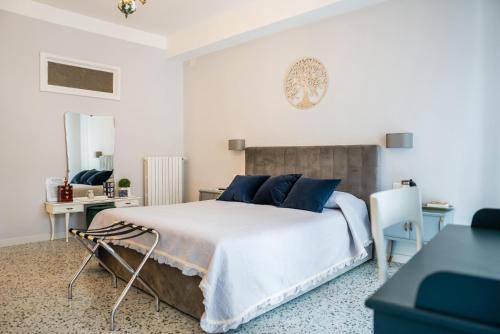 a bedroom with a large bed with blue pillows at B & B L'ABBRACCIO in Agnone