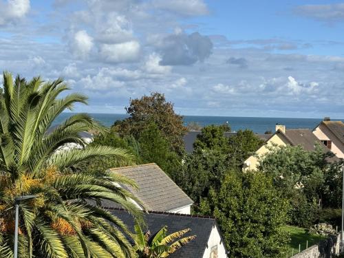 a view of the ocean from a residential neighborhood at les dunes proche plage jardin in Urville-Nacqueville