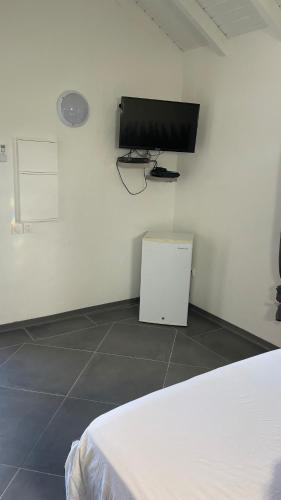 a room with a flat screen tv on the wall at Gab house in Capesterre-de-Marie-Galante