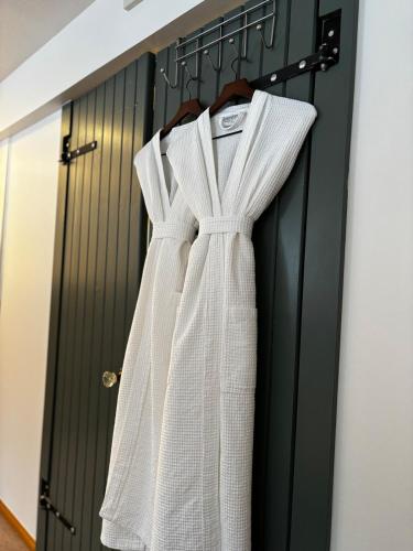 a white dress is hanging on a door at Amazing Views, Northern Lights, Stargazing Entire Guest Suite in Golden, BC Canada in Golden