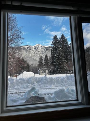 a window with a view of a snow covered field at Amazing Views, Northern Lights, Stargazing Entire Guest Suite in Golden, BC Canada in Golden