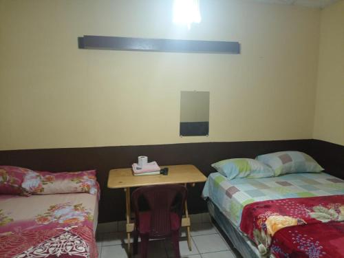 Postel nebo postele na pokoji v ubytování HOTEL EL EDEN