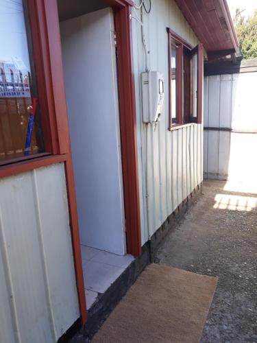 an entrance to a building with a white door at Cabaña para 2 personas en Valdivia in Valdivia