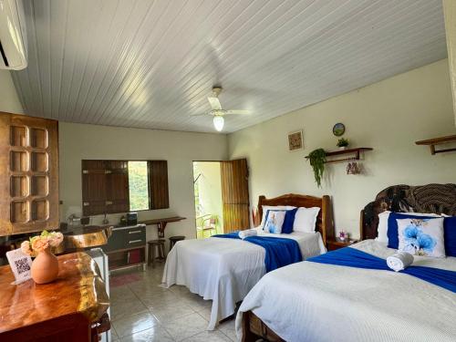 a hotel room with two beds and a kitchen at FLAT 234 Hotel Pedra Rodeadouro in Bonito